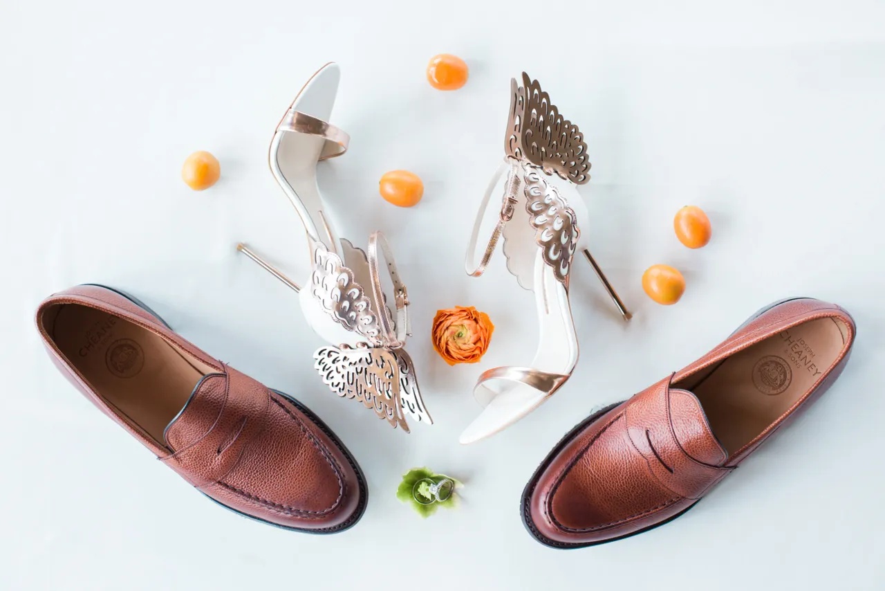 Shoe detail — the bride's winged heels and the groom's penny loafers.